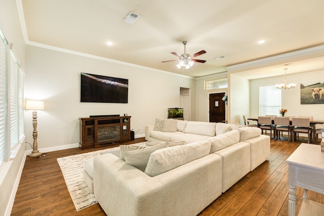 living room with ceiling fan with notable chandelier, dark hardwood / wood-style flooring, and crown molding