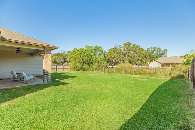 view of yard with a patio and ceiling fan