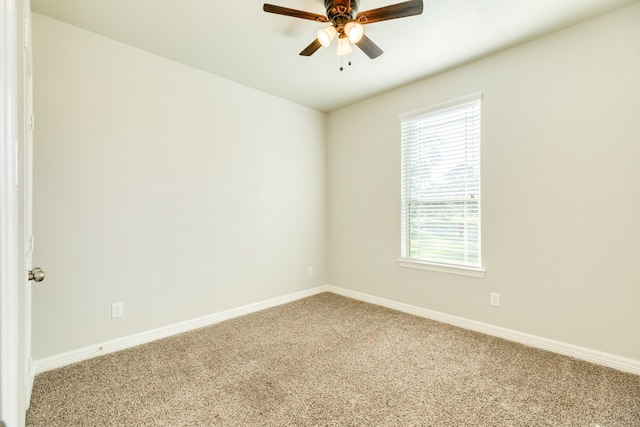 carpeted empty room featuring ceiling fan and plenty of natural light