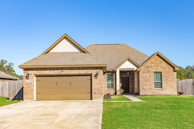 view of front of property featuring a garage and a front lawn