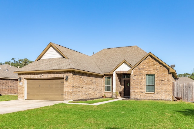 view of front of home with a garage and a front yard