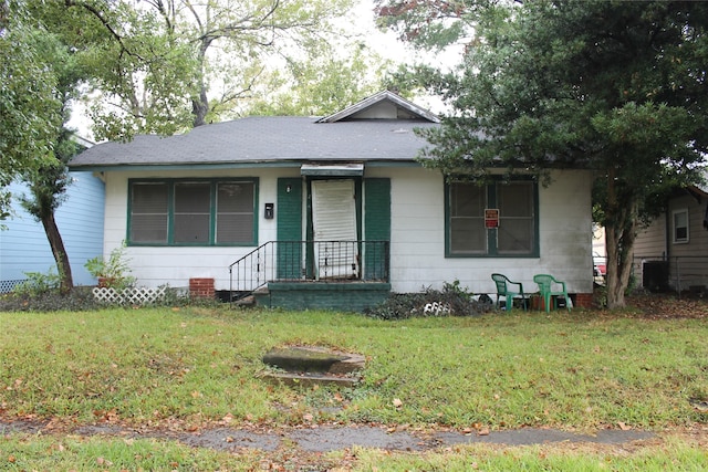 bungalow with central AC unit, a porch, and a front lawn