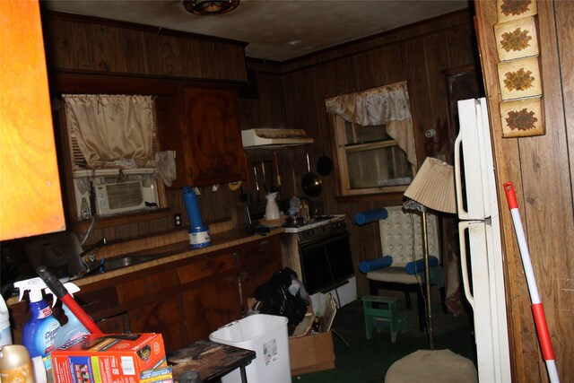 kitchen featuring wood walls, white appliances, and cooling unit