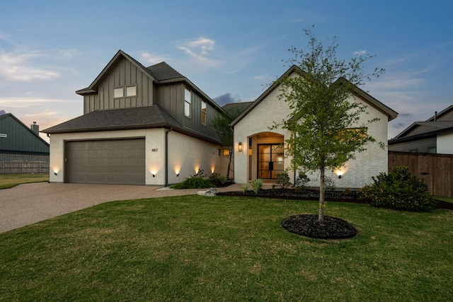 view of front of house featuring a garage and a yard