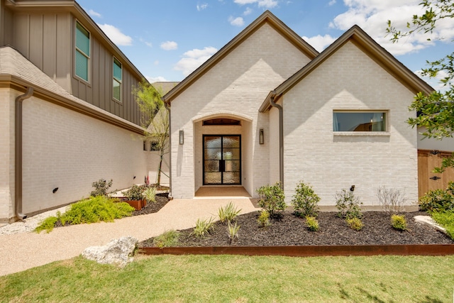 doorway to property with a lawn