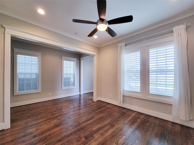 empty room featuring ornamental molding, dark wood-type flooring, and ceiling fan