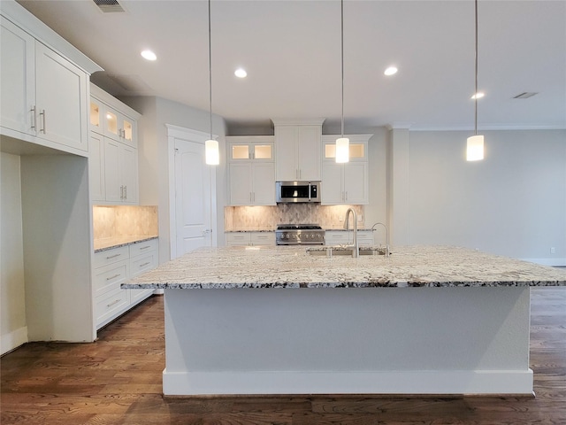 kitchen with hanging light fixtures, sink, a kitchen island with sink, and stainless steel appliances