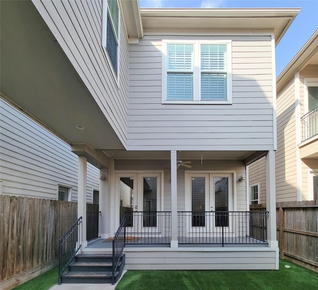 rear view of house with french doors and ceiling fan