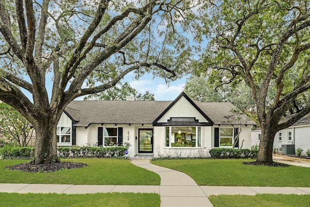 view of front of house featuring a front lawn and central AC unit