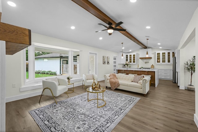 living room with lofted ceiling with beams, ceiling fan, and dark hardwood / wood-style floors