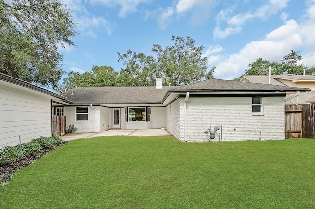 back of property featuring a patio area and a yard