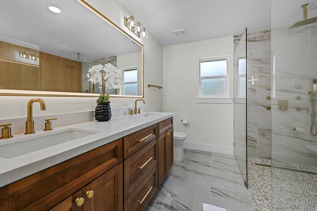 bathroom featuring vanity, a healthy amount of sunlight, and a tile shower