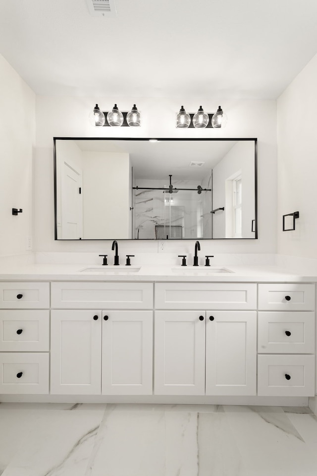 bathroom with walk in shower and vanity