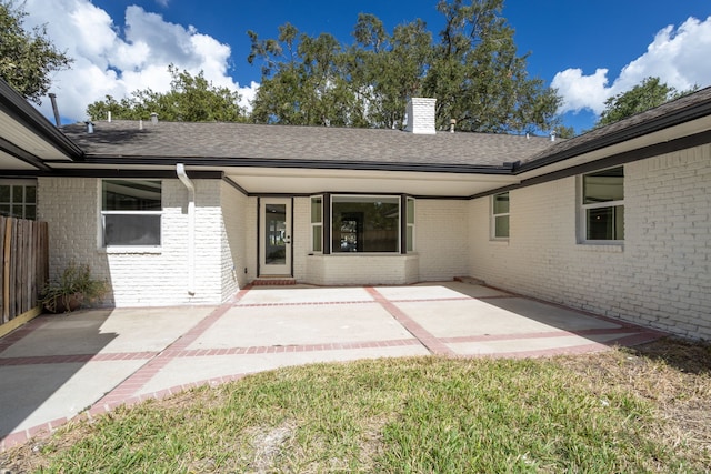 view of exterior entry featuring a patio