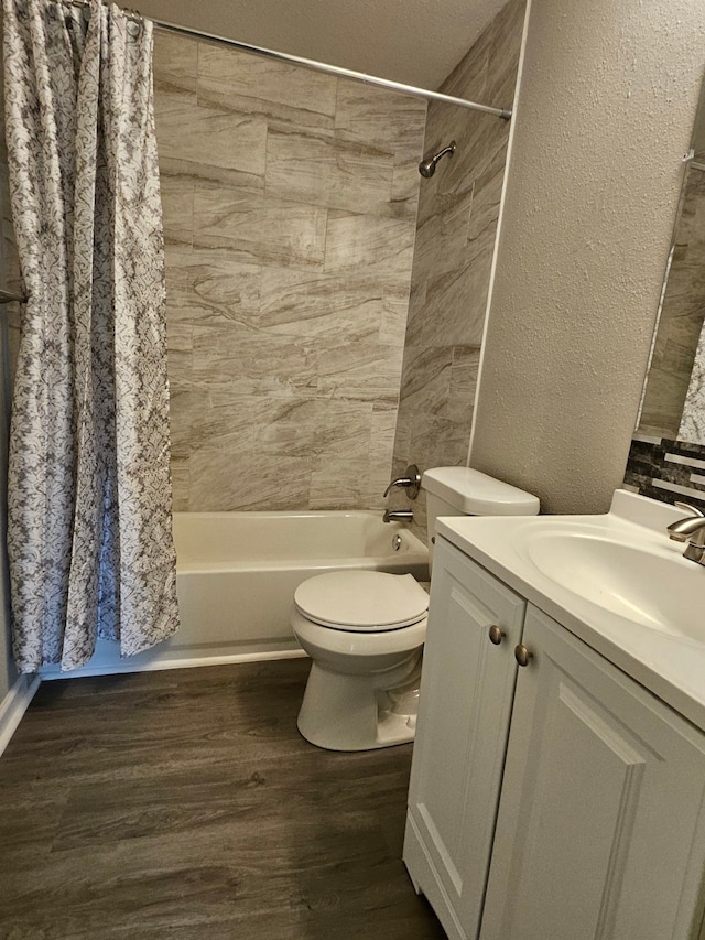 full bathroom with hardwood / wood-style floors, shower / bath combo with shower curtain, vanity, and toilet