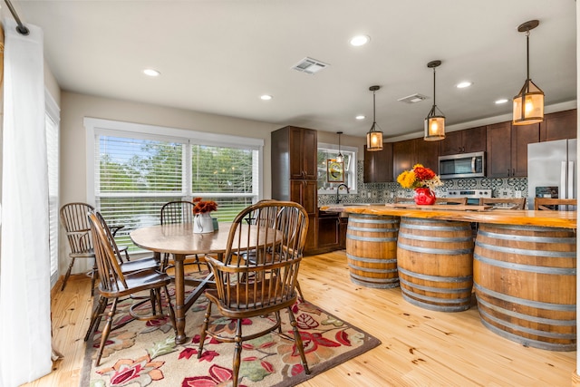 dining room featuring light hardwood / wood-style floors and sink