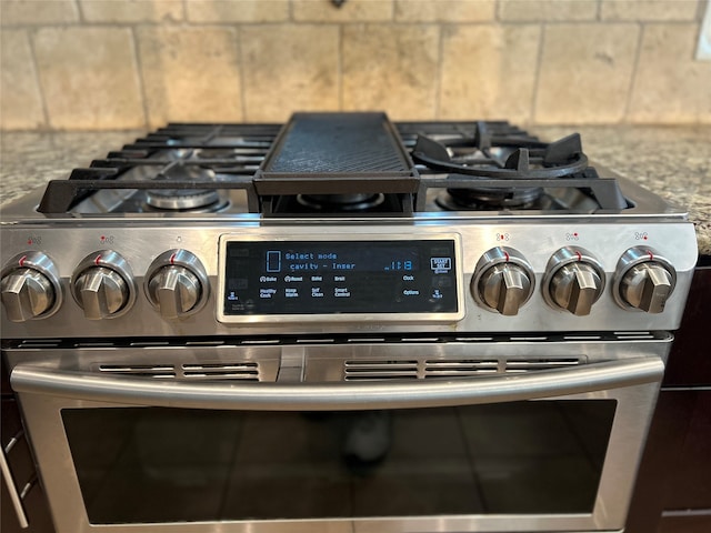 room details featuring range with two ovens and light stone counters