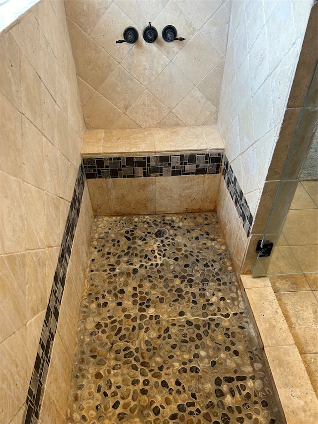 bathroom with tiled shower