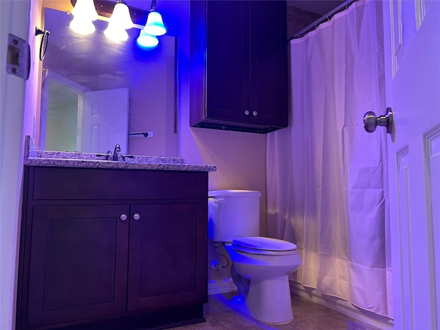 full bathroom featuring vanity, toilet, shower / bath combo with shower curtain, and tile patterned floors