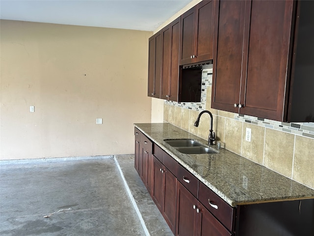 kitchen with backsplash, sink, and stone countertops