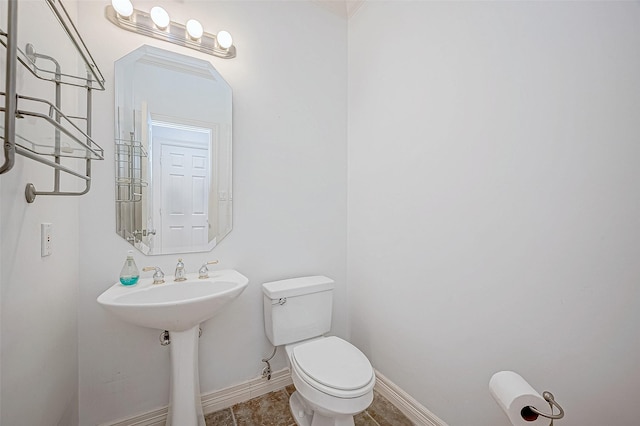 bathroom featuring toilet and crown molding