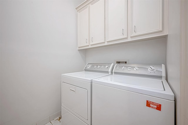 laundry area featuring cabinets and washer and clothes dryer