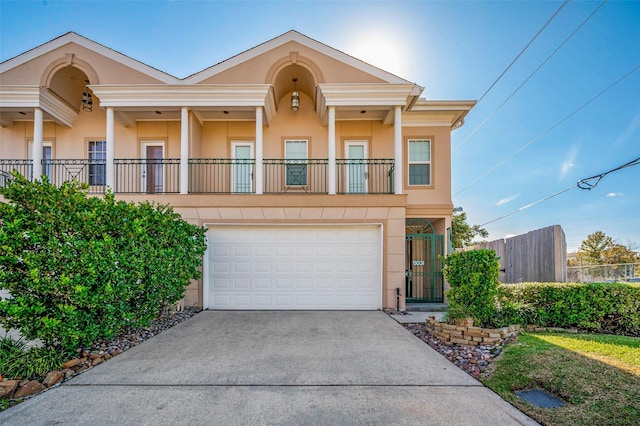 5031 Nolda St, Houston, TX 77007 - view of front of house with a balcony, concrete driveway, fence, a garage, and stucco siding