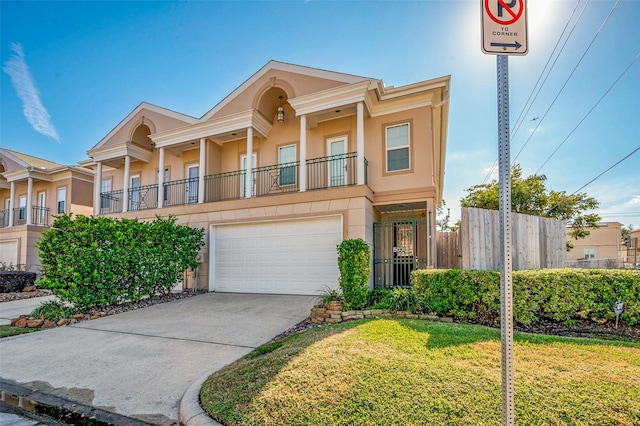 view of front of property with a garage, a balcony, and a front lawn