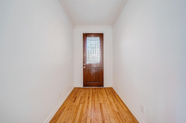 entryway with light hardwood / wood-style floors and ornamental molding