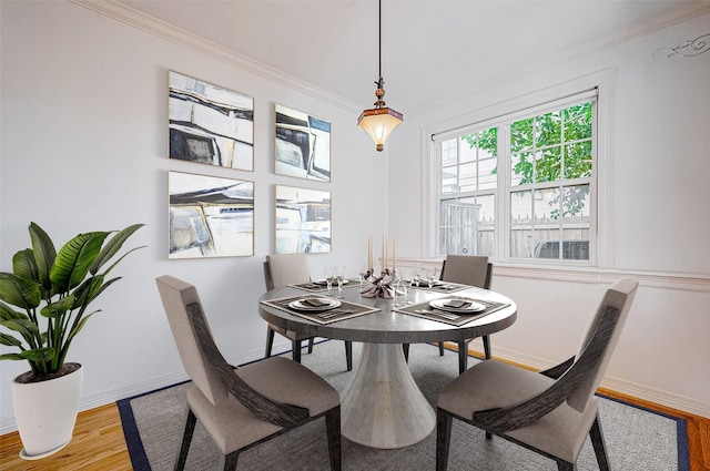 dining space featuring crown molding and hardwood / wood-style floors