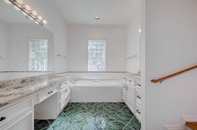 bathroom featuring tiled bath, crown molding, tile patterned flooring, and vanity