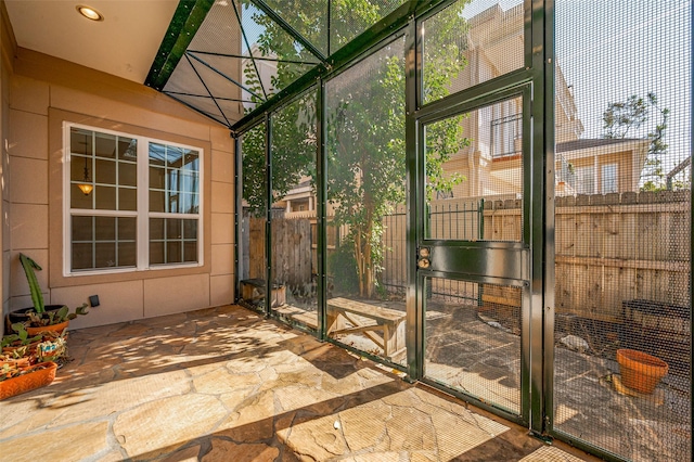 sunroom / solarium featuring beam ceiling