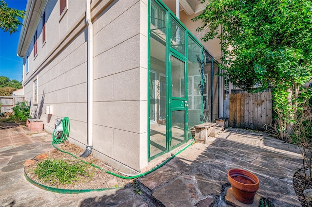 view of property exterior with a patio area