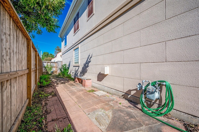 view of side of property featuring a patio