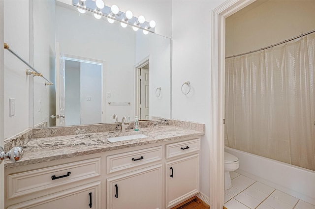 full bathroom featuring tile patterned flooring, shower / bath combination with curtain, vanity, and toilet