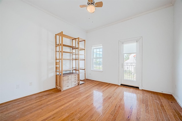 spare room with light wood-type flooring, ceiling fan, and crown molding