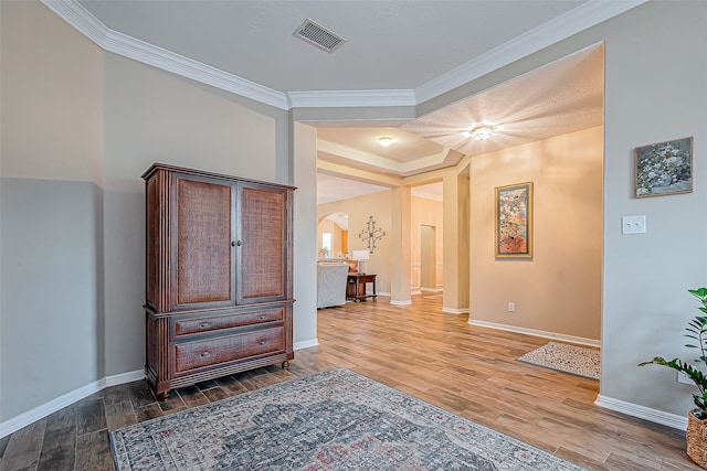 hall featuring hardwood / wood-style floors and ornamental molding