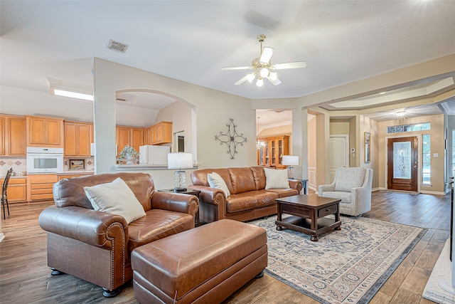 living room featuring dark hardwood / wood-style floors and ceiling fan