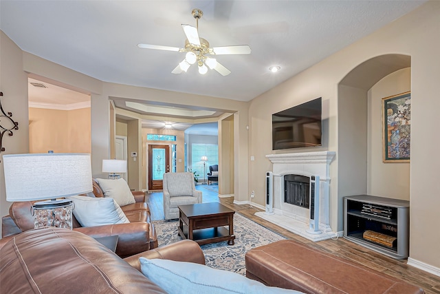 living room with ornamental molding, hardwood / wood-style floors, and ceiling fan