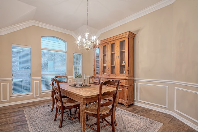 dining space with vaulted ceiling, dark hardwood / wood-style floors, a chandelier, and crown molding