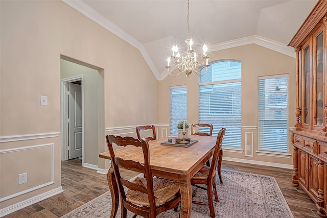 dining area with an inviting chandelier, vaulted ceiling, dark hardwood / wood-style floors, and crown molding