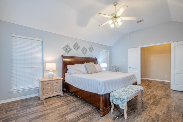 bedroom with ceiling fan, dark hardwood / wood-style floors, and vaulted ceiling