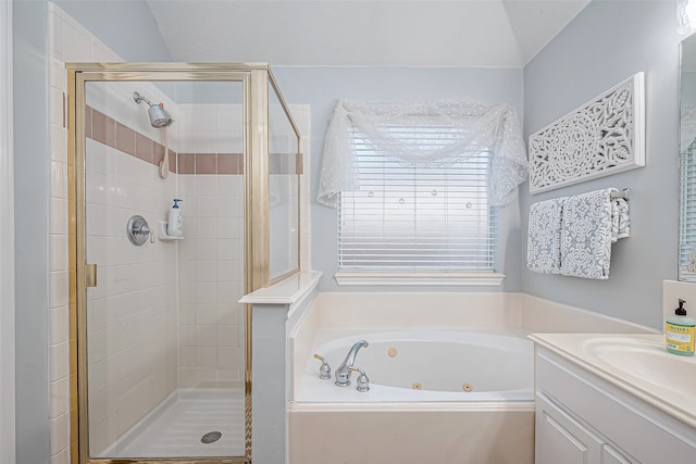 bathroom featuring vanity, shower with separate bathtub, and vaulted ceiling