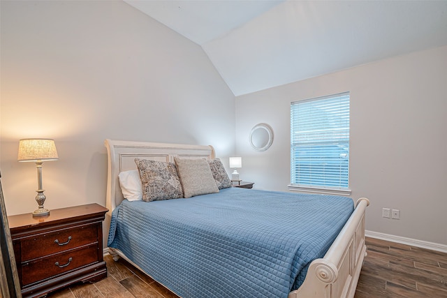 bedroom with lofted ceiling and dark wood-type flooring