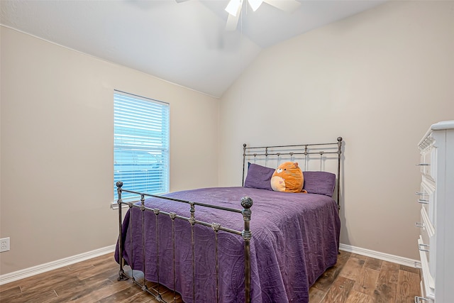 bedroom with hardwood / wood-style floors, ceiling fan, and vaulted ceiling