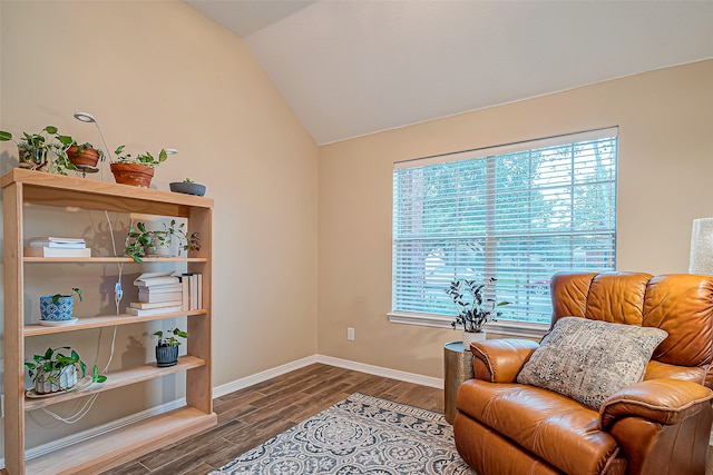 sitting room with hardwood / wood-style floors and vaulted ceiling