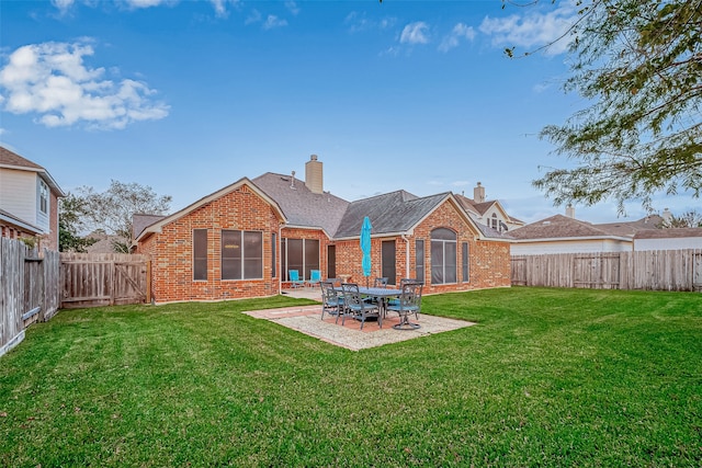 back of property with a lawn and a patio area