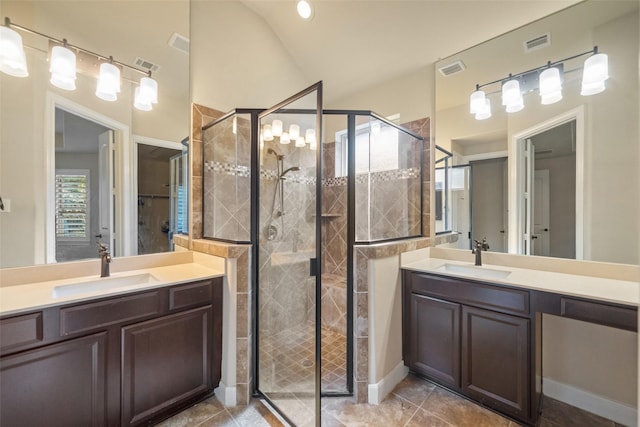 bathroom featuring tile patterned flooring, vanity, lofted ceiling, and walk in shower