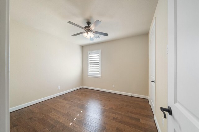 spare room featuring ceiling fan and dark wood-type flooring