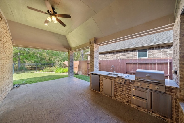 view of patio featuring ceiling fan, a grill, exterior kitchen, and sink